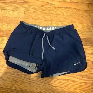 Nike womens navy 2 in 1 running shorts.